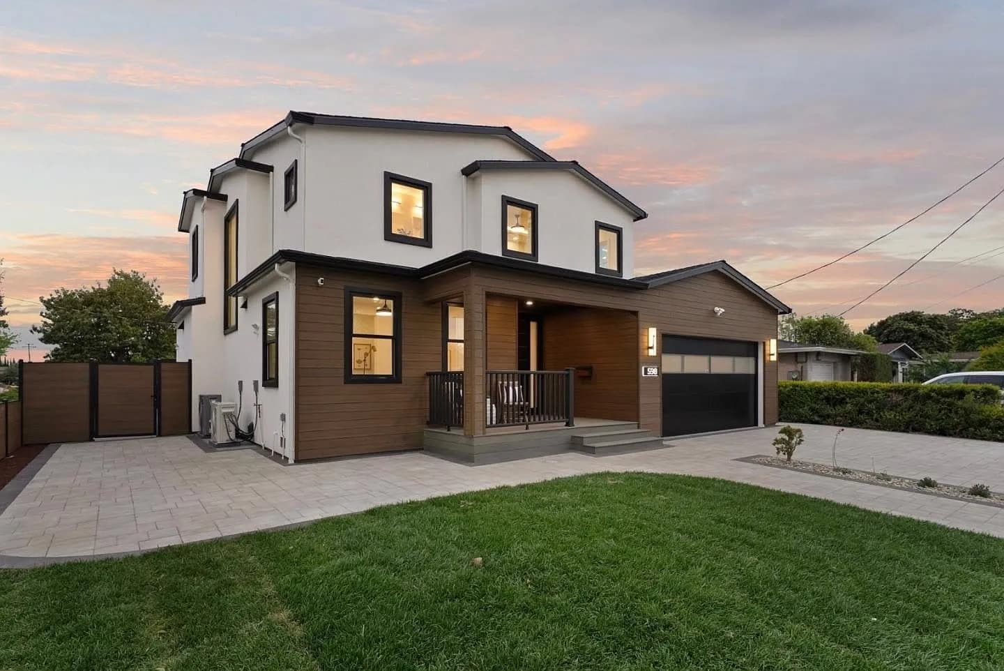 Modern two-story custom home exterior at dusk